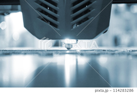 3D printer working close-up. 3D printer prints a model from molten yellow plastic close-up. 3D printer printing object. New modern prototyping technologies. Additive progressive high-tech technology. 3D printer working close-up. 3D printer prints a model from molten yellow plastic close-up. 3D printer printing object. New modern prototyping technologies. Additive progressive high-tech technology. 114283286