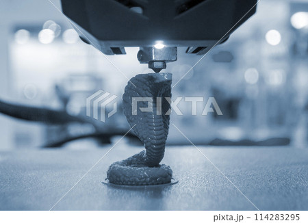 3D printer working close-up. 3D printer prints a model from molten yellow plastic close-up. 3D printer printing object. New modern prototyping technologies. Additive progressive high-tech technology. 3D printer working close-up. 3D printer prints a model from molten yellow plastic close-up. 3D printer printing object. New modern prototyping technologies. Additive progressive high-tech technology. 114283295