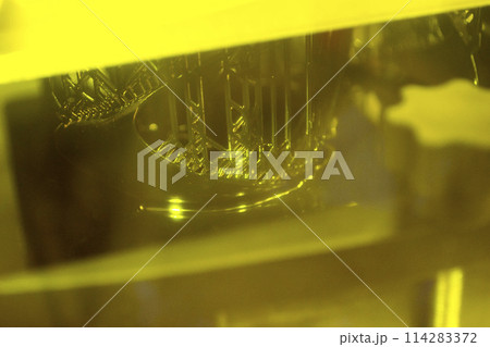 Working of photopolymer sla 3D printer. Platform with building object lowered into liquid photopolymer resins and hardened under ultraviolet laser. Progressive additive technology. 3D printer printing 114283372
