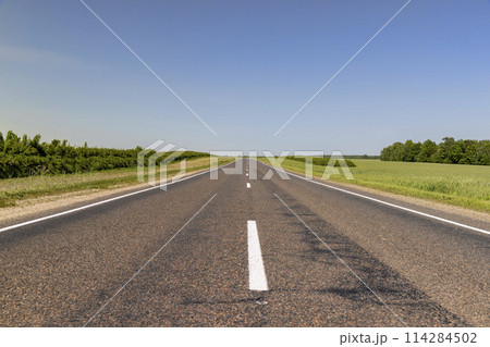 paved road with white line markings 114284502