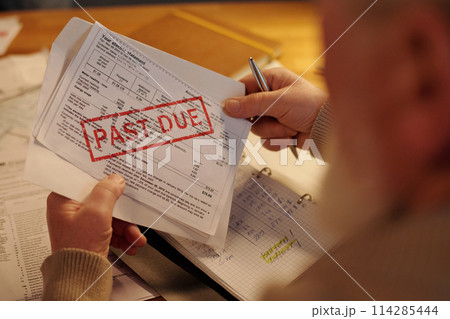 Hands of man with unpaid financial bill Hands of man with unpaid financial bill 114285444