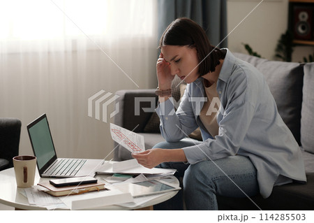Troubled woman with past due bill Troubled woman with past due bill 114285503