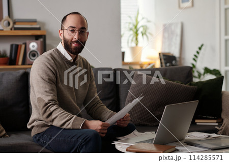 Smiling man with financial documents Smiling man with financial documents 114285571