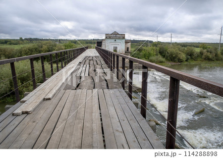 View of the dam of the abandoned Kiik Hydroelectric Power station under a stormy sky 114288898