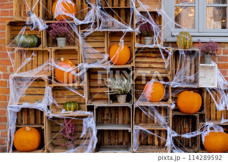 Halloween fall decorated outdoor cafe or restaurant terrace in America or Europe with pumpkins autumn flowers traditional attributes of Halloween. Frontyard decoration Halloween fall decorated outdoor cafe or restaurant terrace in America or Europe with pumpkins autumn flowers traditional attributes of Halloween. Frontyard decoration 114289592