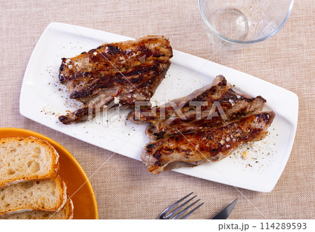 Fried veal steak served in a plate on the table 114289593