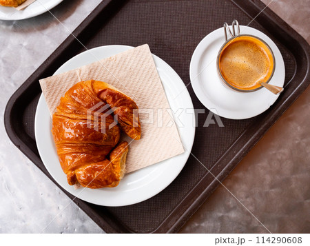 Croissant served for breakfast with cup of coffee 114290608