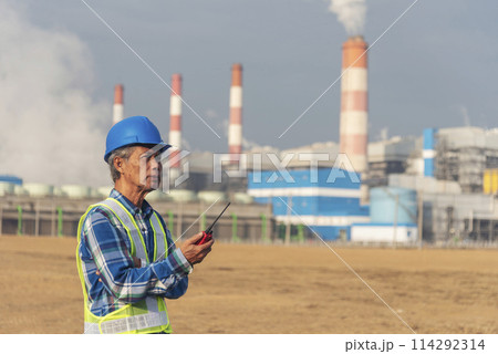 Senior Electrician engineer man hand holding red Walkie talkie communicate wear White hardhat at Power stations manufacturing electrical plant. Technician worker blue hard hat helmet Engineer industry Senior Electrician engineer man hand holding red Walkie talkie communicate wear White hardhat at Power stations manufacturing electrical plant. Technician worker blue hard hat helmet Engineer industry 114292314