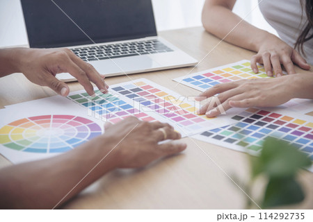 Interior designer team partner engineer brainstorming choosing color swatch. Asian Engineer man contractor brainstorming teams partner meeting together. Paint palette architecture plan in office desk 114292735