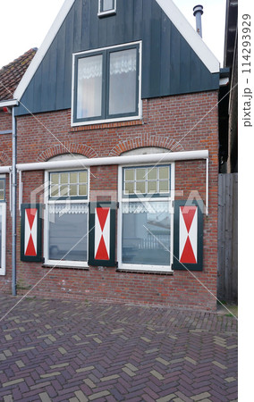 Beautiful wooden houses. Typical small Dutch houses facades in Volendam, Netherlands Beautiful wooden houses. Typical small Dutch houses facades in Volendam, Netherlands 114293929
