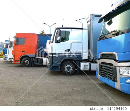 Trucks at parking lot. Delivery Trucks. Cargo Shipping. Lorry. Industry Freight Truck Logistics Cargo Transport Concept. Trucks at parking lot. Delivery Trucks. Cargo Shipping. Lorry. Industry Freight Truck Logistics Cargo Transport Concept. 114294160