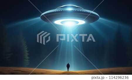 The silhouette of a man stands at night in the beam of a huge flying saucer 114296236