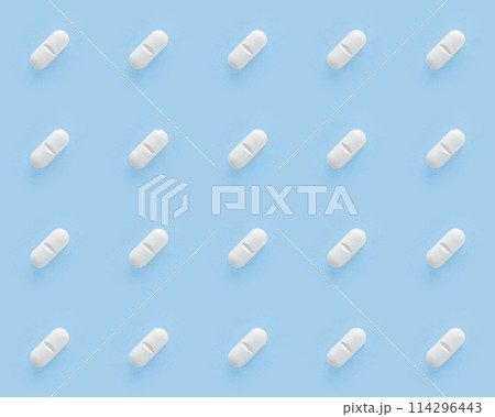 White pills capsules on blue background. Seamless repetitive pills 114296443