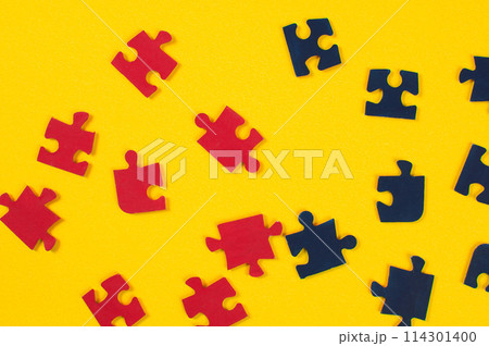 Colorful jigsaw puzzle pieces on yellow background. Top view. Colorful jigsaw puzzle pieces on yellow background. Top view. 114301400