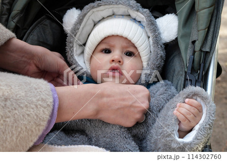 Happy little baby boy making outdoors in winter. Cute toddler in winter cloth. Child having fun on cold day. Winter walk outdoors 114302760