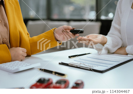 Car Dealership presenting and consult to customer to decision making sign insurance form agreement, Car model, concerning mortgage loan offer in office. Car Dealership presenting and consult to customer to decision making sign insurance form agreement, Car model, concerning mortgage loan offer in office. 114304467