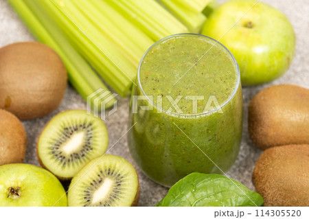 Green smoothie with kiwi, apples, celery, spinach, a healthy natural foods dish 114305520