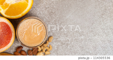 Fruit nut smoothie in a glass on a stone background, copy space for text Fruit nut smoothie in a glass on a stone background, copy space for text 114305536