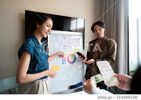 ux developer and ui designer presenting mobile app interface design on whiteboard in meeting at office. Creative digital development mobile app agency. digital transformation ux developer and ui designer presenting mobile app interface design on whiteboard in meeting at office. Creative digital development mobile app agency. digital transformation 114309100