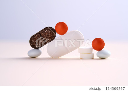 Pills and antibiotics on a blue background. 114309267