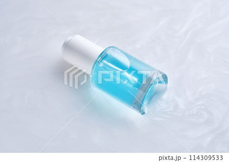 Bottles of serum with a dropper in liquid with pearl tints. Bottles of serum with a dropper in liquid with pearl tints. 114309533