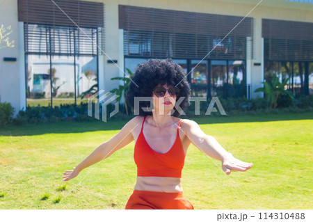 Bright athletic brunette vigorously doing fitness in the early morning 114310488