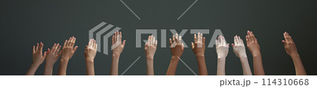 Many hands of diverse people, children raising their hands reaching up against gradient grey background. Many hands of diverse people, children raising their hands reaching up against gradient grey background. 114310668