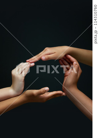 One whole. Diverse children's hands making circle against black background. Racial equality spirit. Unity. 114310760