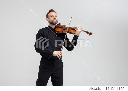 Elegant musician man violinist playing on concert 114311132