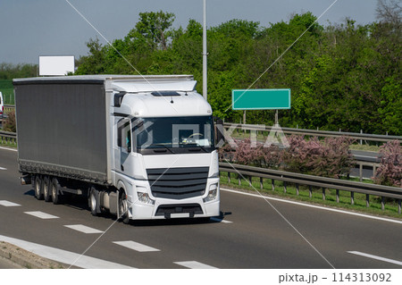 Semi truck with trailer on the highway 114313092