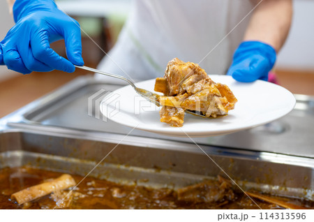 Close up of a Nurse serving food to senior people at nursing home. 114313596