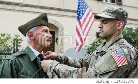Son Fixes Father's Veteran Tie on Memorial Day in America 114315370