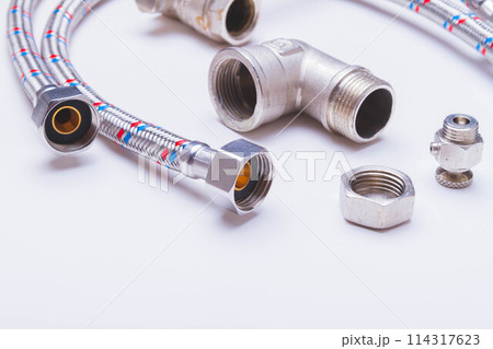 A water tap and a hose in a metal braid. Accessories for the repair of water supply. A water tap and a hose in a metal braid. Accessories for the repair of water supply. 114317623