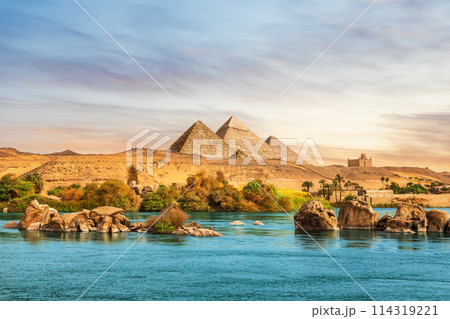 The Nile river and ancient rocks in the Aswan desert by the pyramids, Egypt 114319221
