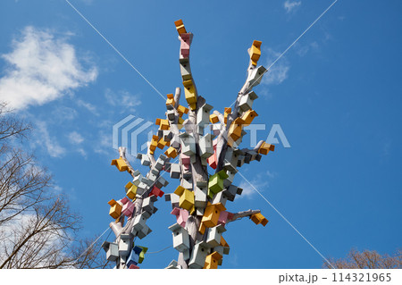 Bird houses on a tree against the sky. Wooden birdhouses, nesting boxes in Esplanade park, Riga, Latvia. 114321965