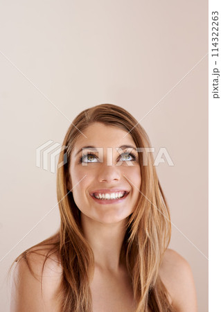 Beauty, hair care and happy woman looking up, skincare and face treatment isolated on a brown studio background mockup space. Thinking, hairstyle and model in makeup cosmetics at hairdresser salon 114322263
