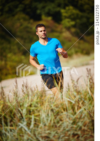 Running, athlete and man, grass and outdoor with energy for practice, exercise and health in nature. Workout, runner and training for marathon, forest and performance of speed for male person 114322750