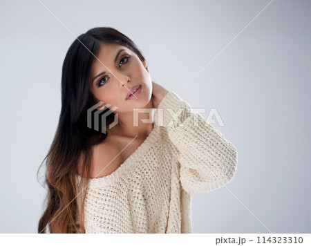 Woman, fashion and hair, portrait and makeup in studio for winter style salon with treatment and wellness on white background. Cosmetics, trendy jersey or sweater with haircare, volume and growth 114323310