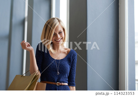 Happy, smile and woman with shopping bags in fashion mall, shop or boutique for gift. Excited, customer and young female person with style clothing at retail store for sale, discount or promotion. 114323353