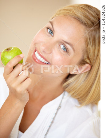 Happy woman, holding and apple in portrait for health, nutrition or wellness. Female person, smile and fruit in hand for wellbeing, vitamin or fibre with choice for natural, fresh or organic diet Happy woman, holding and apple in portrait for health, nutrition or wellness. Female person, smile and fruit in hand for wellbeing, vitamin or fibre with choice for natural, fresh or organic diet 114324626
