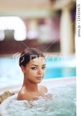 Woman, portrait and hot tub for calm at spa hotel or stress relief treatment or hydrotherapy, resort or hospitality. Female person, jacuzzi and accommodation in Miami or hygiene, resting or travel 114324870