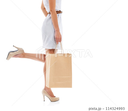 Woman, high heels and hands in studio with shopping bag for style, sale or feet by white background. Girl, person and shoes in mockup space, clothes and discount with retail deal, product and fashion Woman, high heels and hands in studio with shopping bag for style, sale or feet by white background. Girl, person and shoes in mockup space, clothes and discount with retail deal, product and fashion 114324993