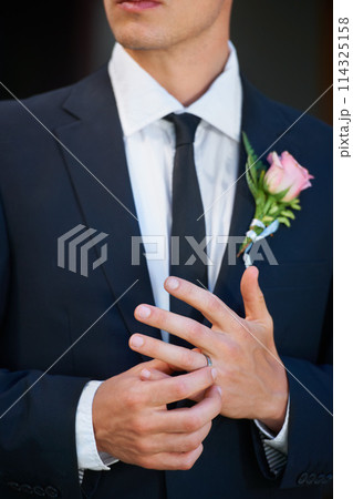 Man, groom and hands with wedding ring for marriage, commitment or symbol of love, trust or care. Closeup of married male person in suit with flower and jewelry for vow, promise or engagement event 114325158