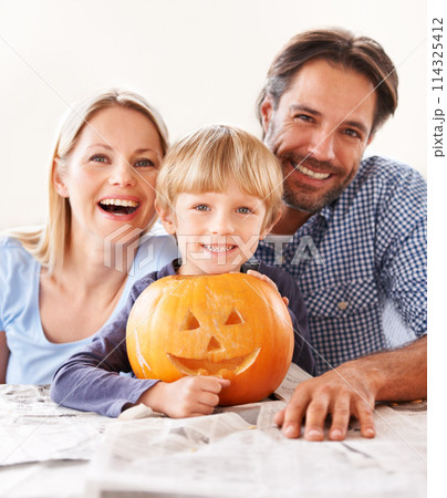 Portrait, parents and kid with pumpkin for halloween to celebrate with fun together. Happy family, mom and dad with boy child carving face in vegetable for holiday lantern, decoration and party Portrait, parents and kid with pumpkin for halloween to celebrate with fun together. Happy family, mom and dad with boy child carving face in vegetable for holiday lantern, decoration and party 114325412