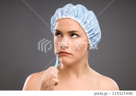 Woman, brushing teeth and studio for hygiene, health and annoyed with thinking by gray background. Girl, person or model with toothbrush, dental care and oral wellness for mouth in morning routine 114325496