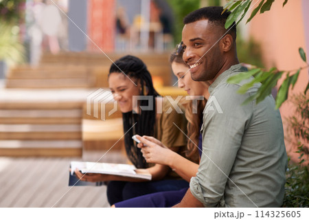 Young man, friends and smile on campus or college for studying, relaxing and chilling together outside. Diverse people, group and happy with textbook, phone and internet for learning and bonding Young man, friends and smile on campus or college for studying, relaxing and chilling together outside. Diverse people, group and happy with textbook, phone and internet for learning and bonding 114325605
