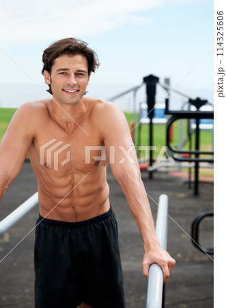 Man, smile and bars in portrait, fitness and outdoor equipment for workout, strong arms and muscle from exercise. Happy male athlete, body building and training results at gym, health and shirtless 114325606