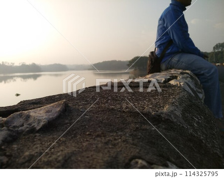 A man who is enjoying the natural scenery with an eye on the future A man who is enjoying the natural scenery with an eye on the future 114325795