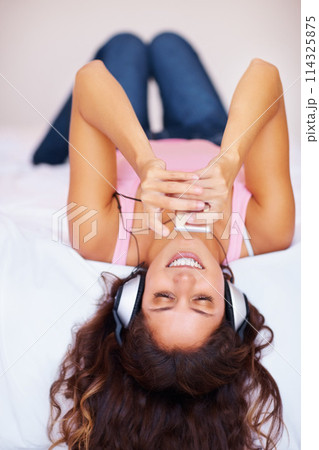 Headphones, smile and woman with player on bed, streaming and relax at home in the morning. Music, happy person on technology in bedroom and listen to radio or audio, sound or song on internet app 114325875