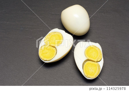 egg with two yolks on a black background. egg with two yolks on a black background. 114325978